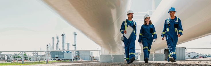 Engineers in workwear walking through industrial plant