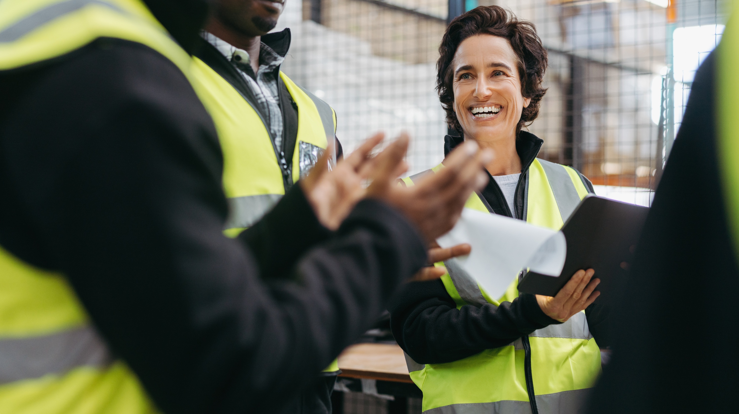 An engineer is applauded by her team 
