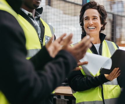 An engineer is applauded by her team
