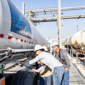 Engineers walking across the plant and pointing to something