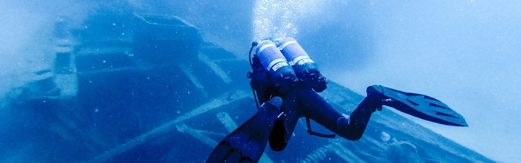 Diver swimming under water