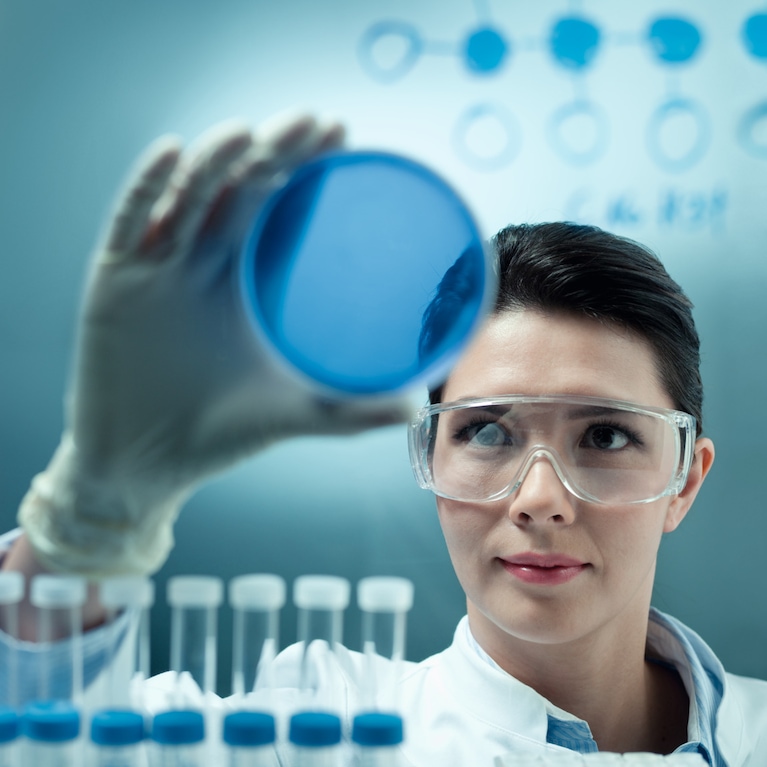 Woman examining a petri dish