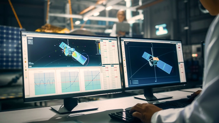 Engineer designing spacecraft component