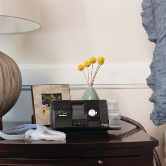 CPAP device and mask on nightstand
