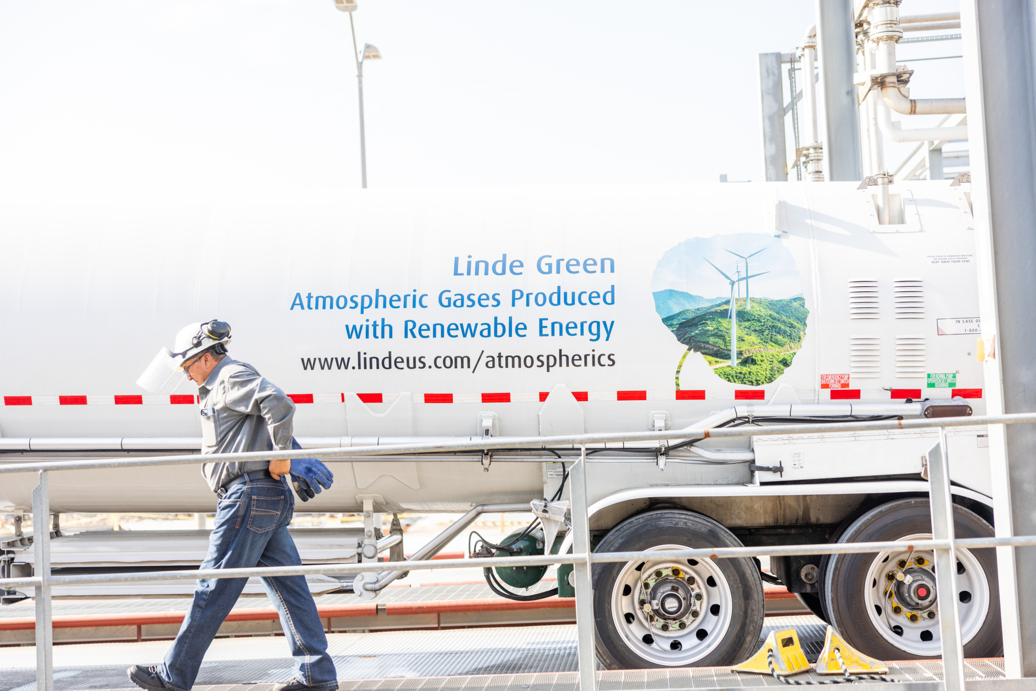 Driver walking along side of Linde Green hydrogen truck