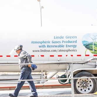 Driver walking along side of Linde Green hydrogen truck