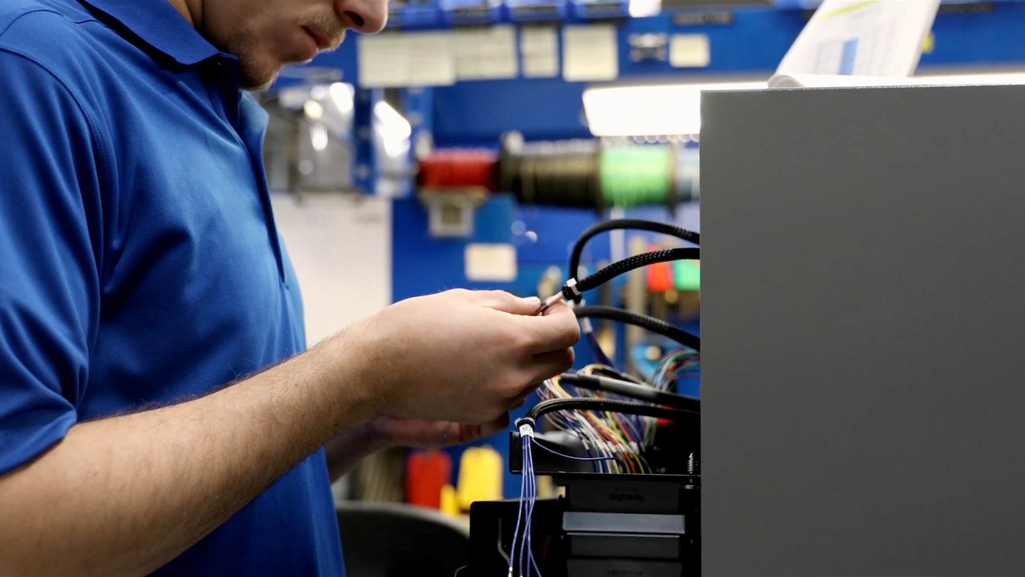 Worker inspecting wires