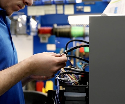 Worker inspecting wires