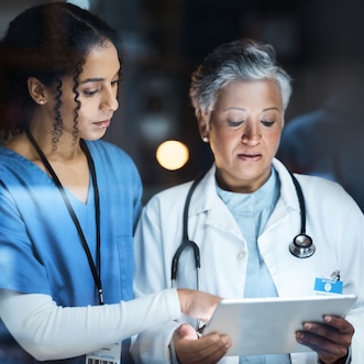 Healthcare professionals reviewing patient chart