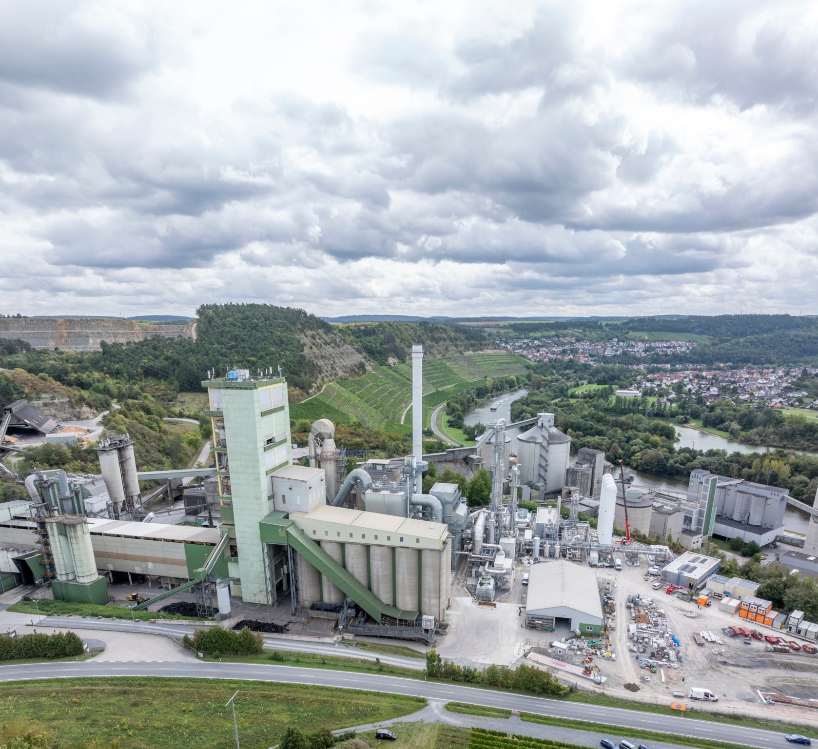 Total view construction site of the CCU plant in Lengfurt, Germany, and the cement plant of Heidelberg Materials - looking from southern direction.