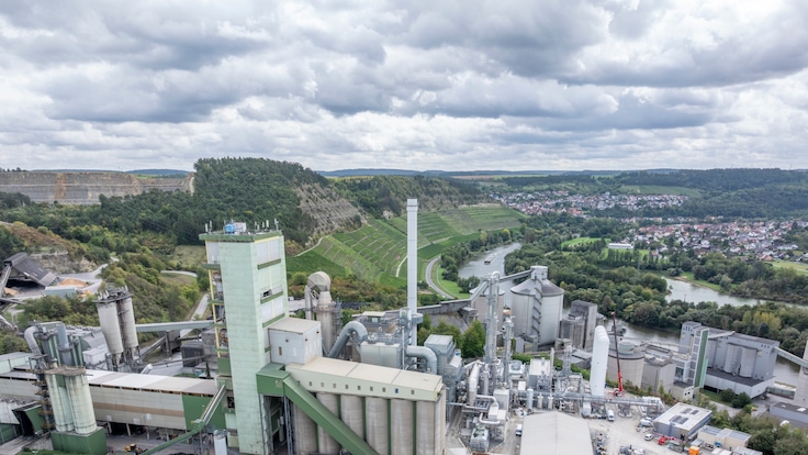 Total view construction site of the CCU plant in Lengfurt, Germany, and the cement plant of Heidelberg Materials - looking from southern direction.