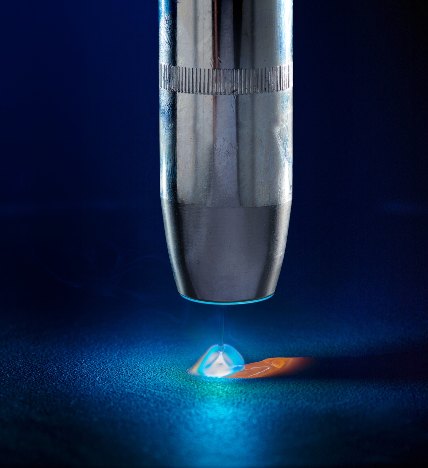 Close up photo of Gas shielded metal arc welding torch, welding arc and molten pool.