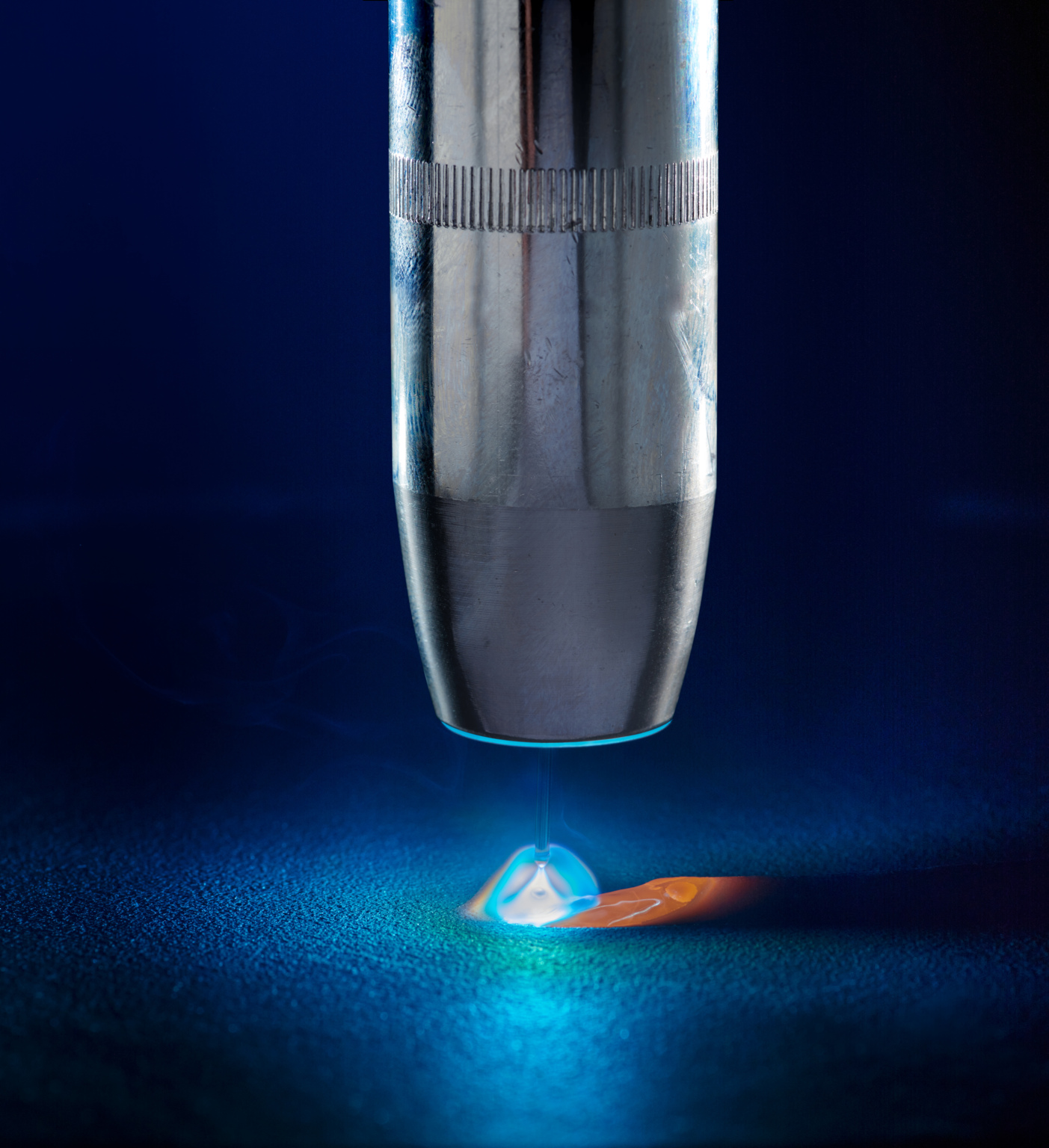 Close up photo of Gas shielded metal arc welding torch, welding arc and molten pool.