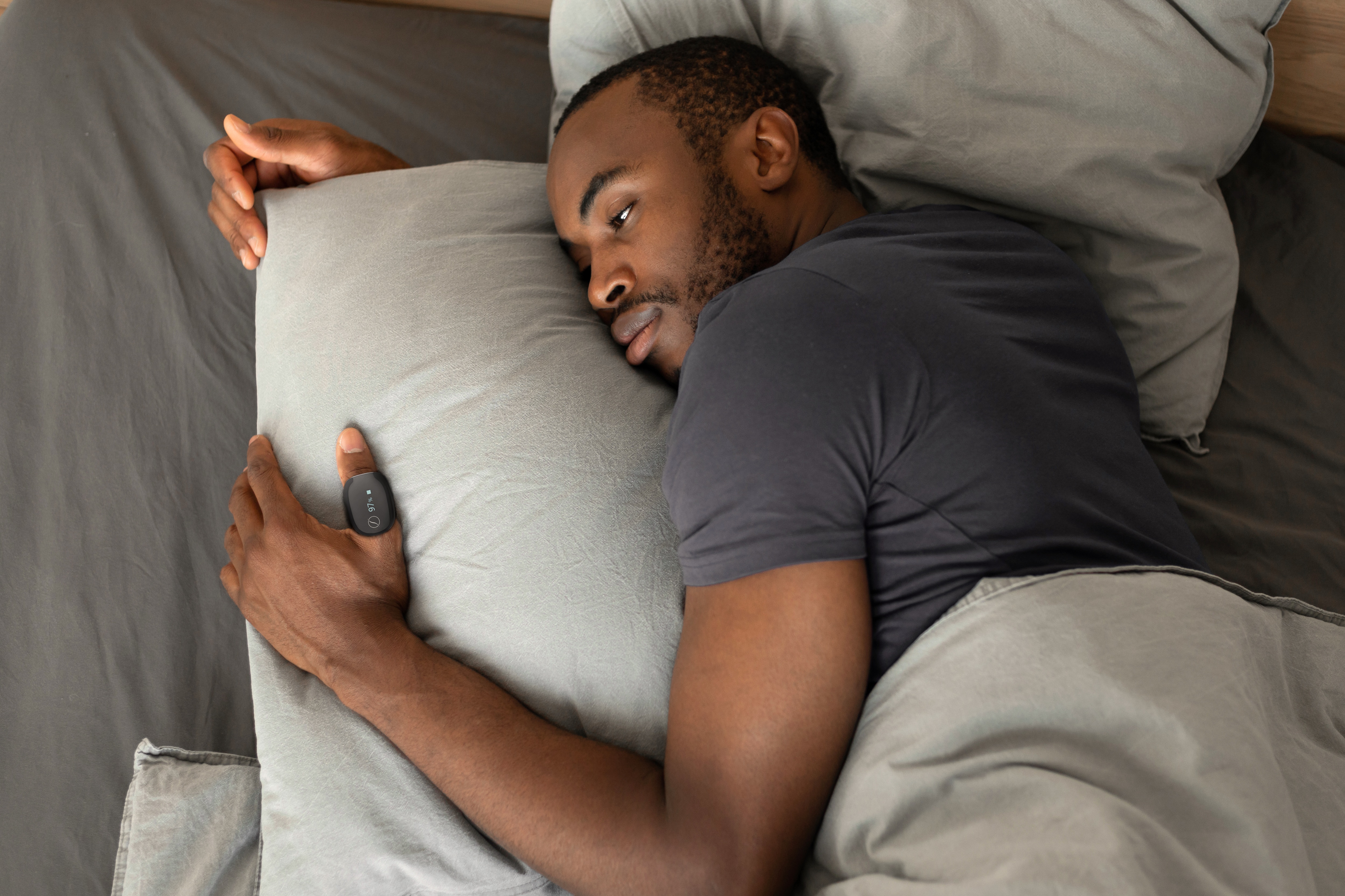 Man sleeping wearing SleepImage adult ring